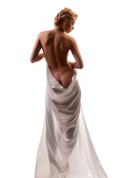 Beautiful naked woman in a white robe on the isolated background